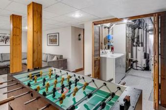 A foosball table and laundry machines are in the basement of 980 Mulligan.