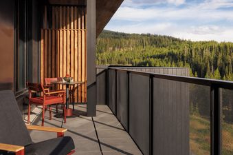 The private balcony of the Moonlight Room overlooking a lush pine forest.