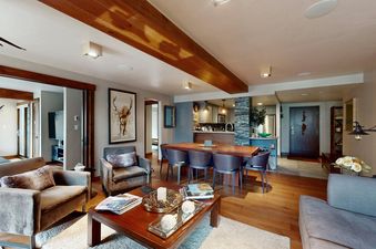 The living area of Fallridge 312 features a spacious open-plan design, connecting the comfortable lounge and elegant dining space.