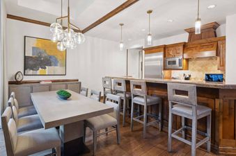 The Aspen 03B features a spacious, modern kitchen with stainless steel appliances and wood cabinetry.