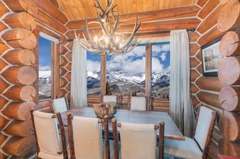 The Villas At Tristant 203 dining area boasts wood finishes and mountain views.