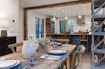Beautifully set dining table leading into an open-concept kitchen at Palomino Ridge.