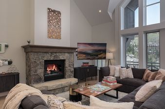 Comfortable lounge area in Chalet Montsor with fireplace and TV.
