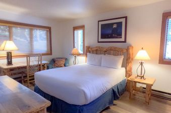 A cozy bedroom at Nez Perce D1 featuring a rustic log bed and natural wood furnishings.