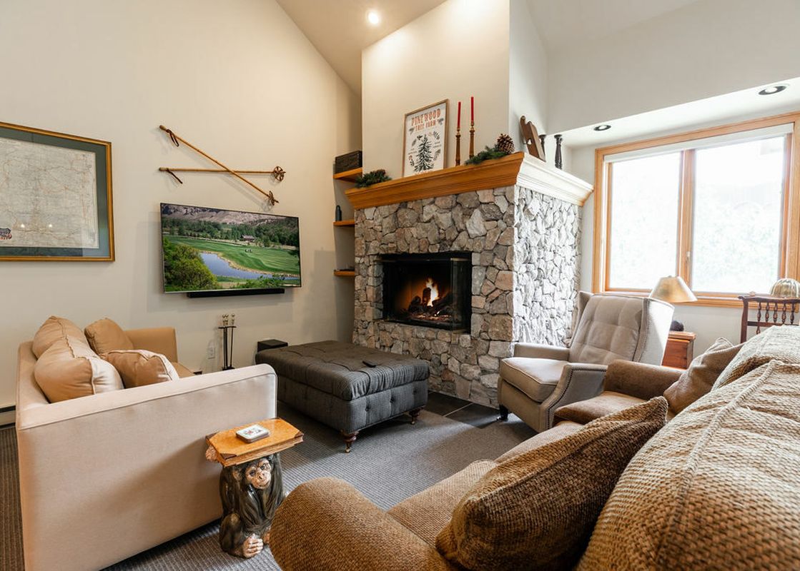 The living area at Strawberry Park 603 features a comfortable fireplace, a large TV, and cozy seating.