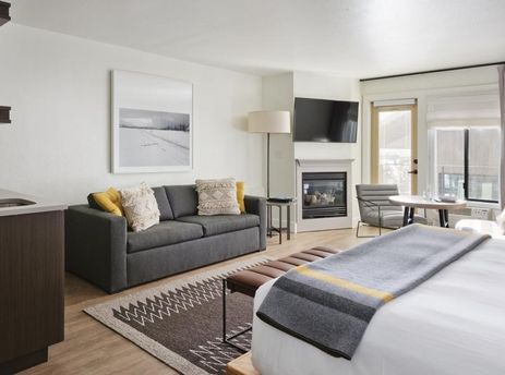 Modern open-concept living area and bedroom in the Gravity Haus JH Premium King Suite.