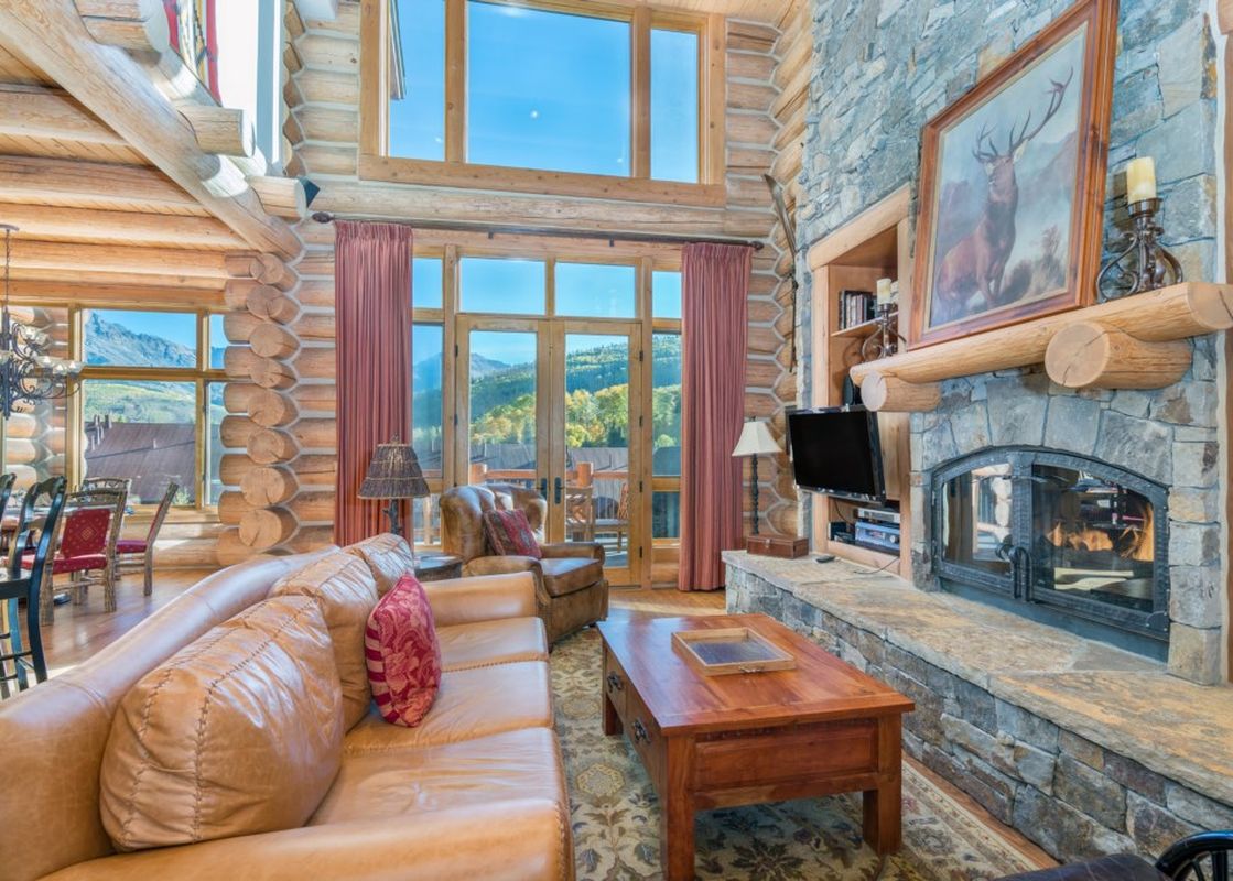 The Villas At Tristant 215 living room features a stone fireplace and cozy seating.