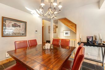 Deer Valley Delight dining room with large wooden table and red leather chairs