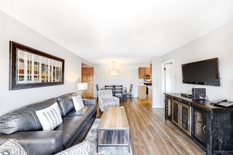 Open-plan living and dining area in Ski Inn Condominium 221.