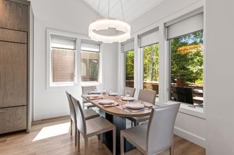 The dining room at Chaparral 204 features a modern dining table with six chairs, set with plates and glasses.