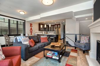 A living room with a fireplace, a large couch, and a coffee table.