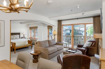 The primary bedroom features a comfortable bed and is connected to the inviting living area.
