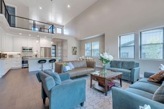 The spacious open-concept living area and modern kitchen of Mayflower Lakeside 9975.