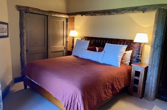 The bedroom in Penthouse At The Peaks 614 features a cozy bed and warm lighting.