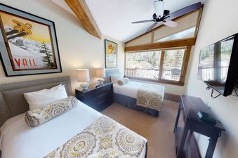 Manor Vail 212 features two bedrooms, one with two twin beds and the other with a king bed.  The living area has vaulted ceilings and a large, flat-screen television. There is a balcony with stunning views of the mountains and a fireplace, perfect for rel