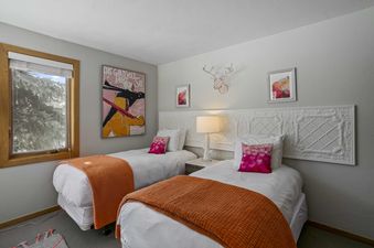 Bedroom with two beds and white linens at 2060 Solamere Drive.