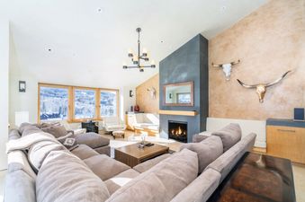 The living room at Peaks Penthouse 851 is cozy and well-lit with lots of seating.