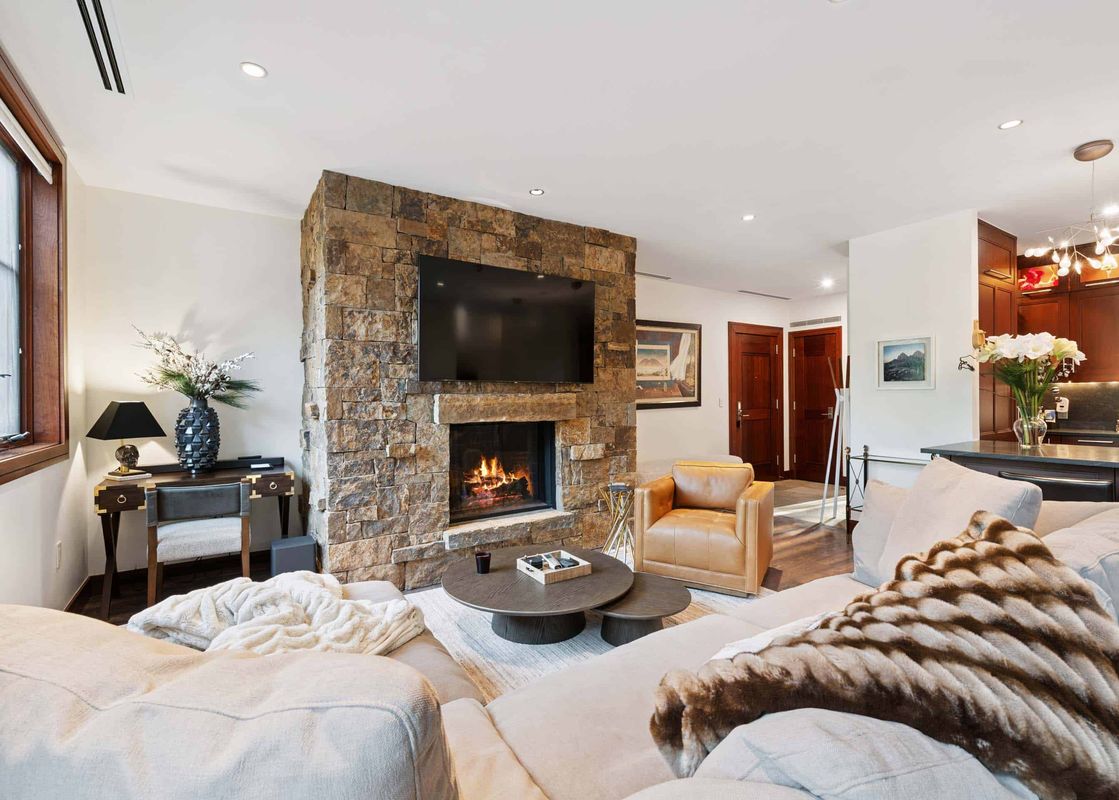 The living area of Solaris 3BS features a cozy fireplace, comfortable seating, and elegant decor, creating a warm and inviting atmosphere.