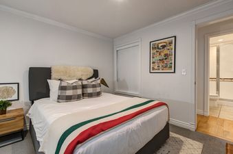 Abode at Watson House features a cozy bedroom with a queen bed and a stylish bathroom.