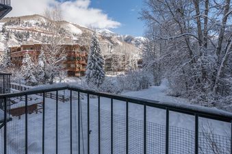 The balcony view from Manitou Lodge 7 offers a serene winter escape with snow-covered scenery.