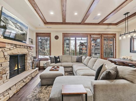 The spacious living area of Shooting Star 304 features a cozy fireplace and comfortable sectional sofa.
