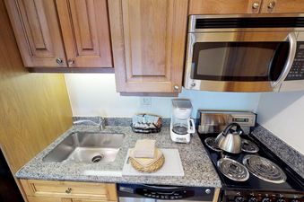 The kitchen in Manor Vail 283 has stainless steel appliances, granite countertops, and a coffee maker.