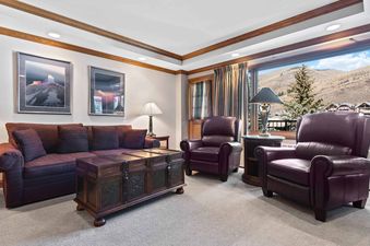 The inviting living area in Lodge Tower 378 features comfortable seating and a picturesque mountain view.