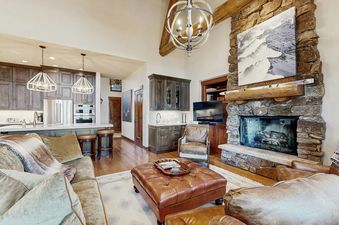 A spacious great room in The Gulch Getaway with a cozy living area and a modern kitchen.