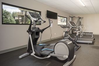 An expansive exercise room at Hi Country Haus 309, featuring diverse fitness equipment.
