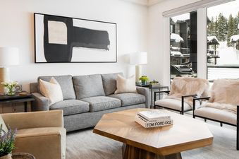 The living room of Moonlight Basin 9 Wildwood features a large, comfortable sofa and a modern coffee table.