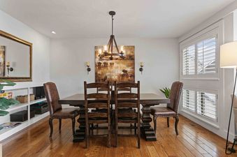 Dining area featuring a wooden table and chairs.