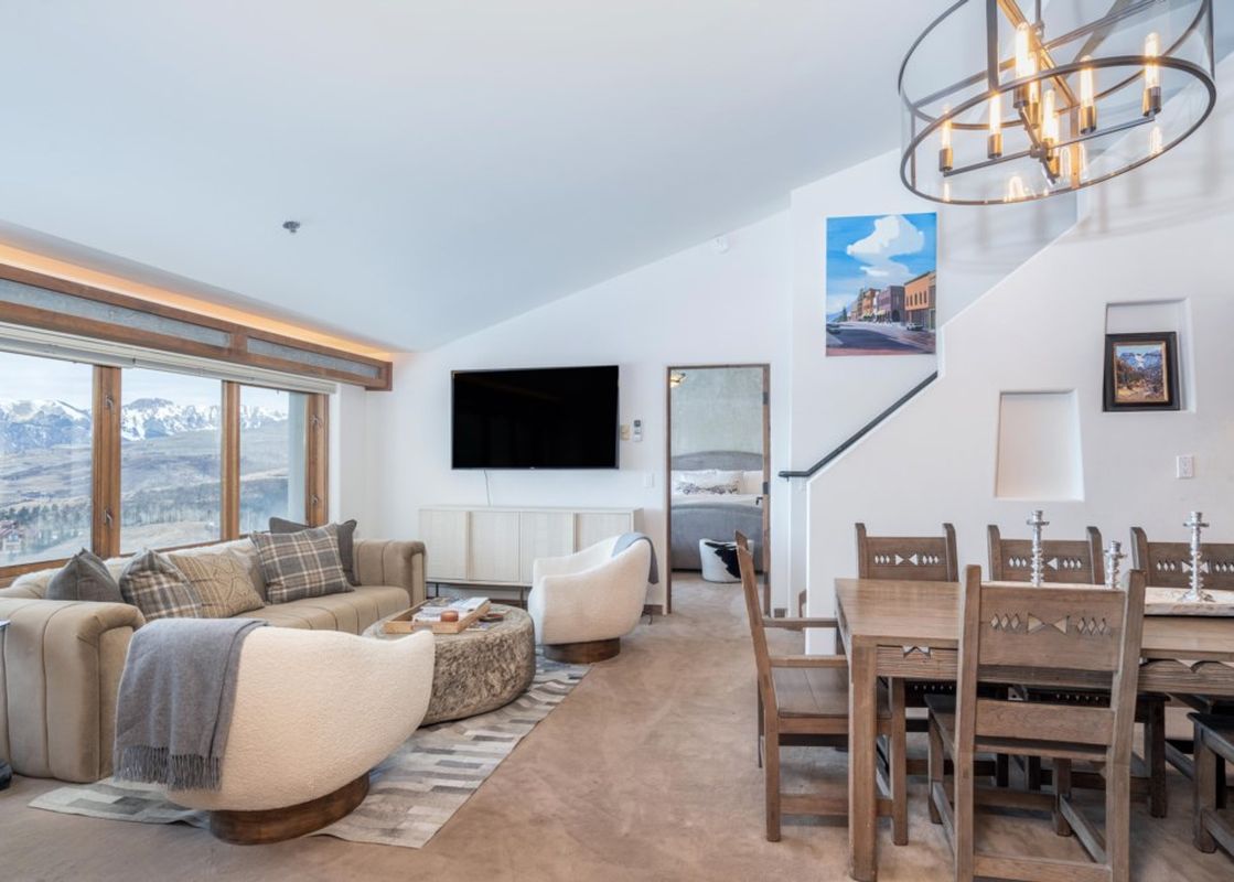 An open-concept living and dining area in Penthouse At The Peaks 826 showcases modern design and comfortable seating.