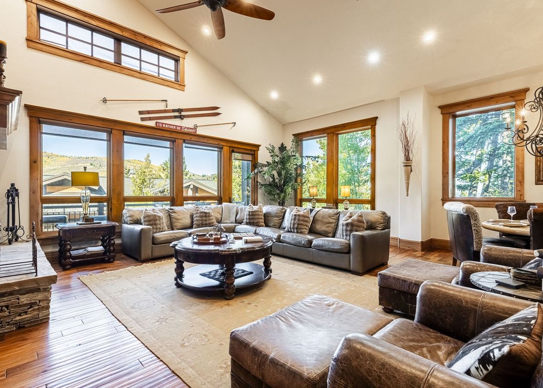 A spacious living room at Deer Valley Lookout 26, featuring comfortable leather sofas, a large coffee table, and an inviting fireplace.