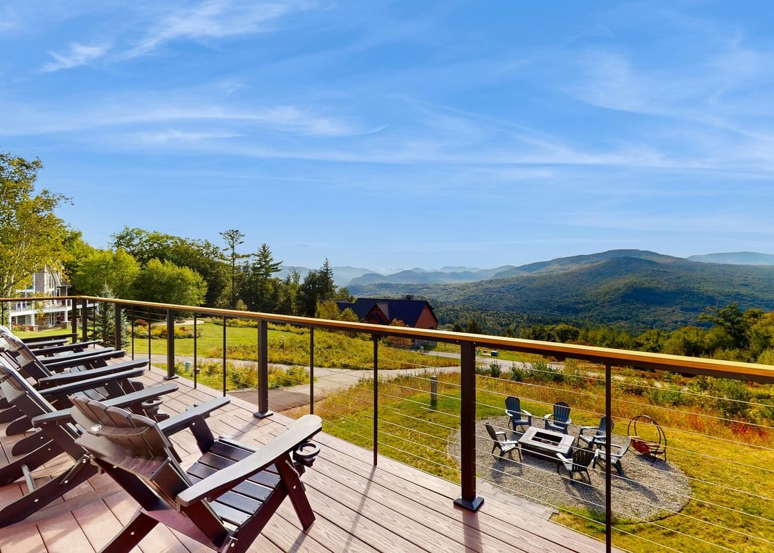 The spacious deck at We Will Ski offers stunning mountain views.