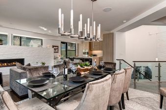 Elegant dining area in Abode at Parkite Penthouse with glass table and fireplace.