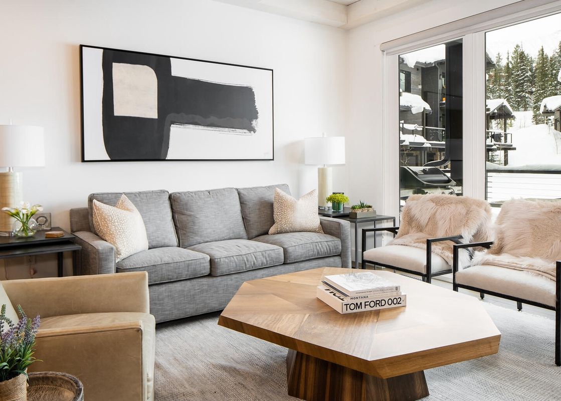 The living room of Moonlight Basin 9 Wildwood features a large, comfortable sofa and a modern coffee table.