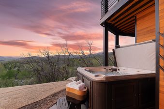 The hot tub on the deck at Raptor Ridge offers a relaxing experience with a beautiful view.
