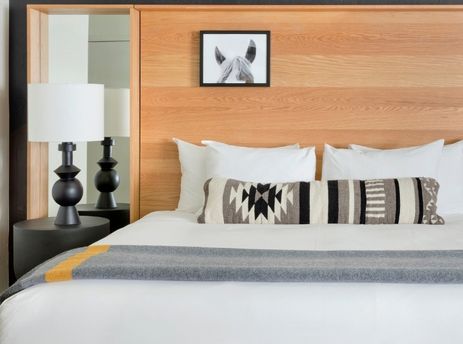 Comfortable king bed details inside the Gravity Haus JH Deluxe Suite.