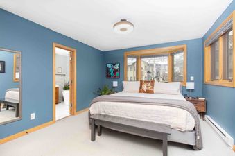 The Lulu City 5D features a cozy bedroom with a large bed and plenty of natural light.