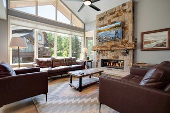 Living room at Bear Lodge BL6111 with leather seating and stone fireplace.