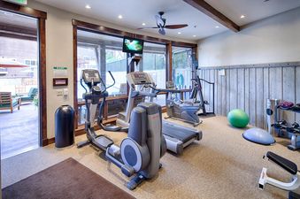 The fitness center at Silver Star 902 features a variety of exercise equipment including ellipticals, treadmills, and stationary bikes, alongside free weights and exercise balls.