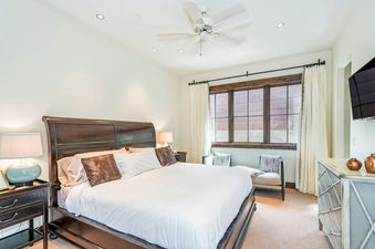 The bedroom in Trails Edge 1 Mountain Village features a king-sized bed and comfortable seating.