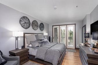 The bedroom in Lorian 7 is decorated in neutral tones with a king-size bed.