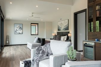 The spacious great room at Yampa Vista Grande features a comfortable living area, bedroom, and bar, all bathed in natural light.