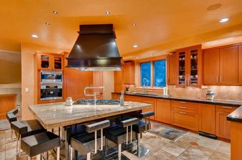 A spacious and modern kitchen with a large island and ample counter space.