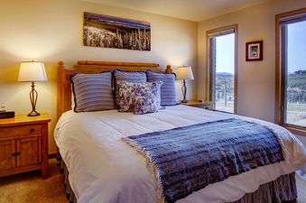 Bedroom in Bear Claw 1 Slope View 203 with a comfortable bed and views from the windows.
