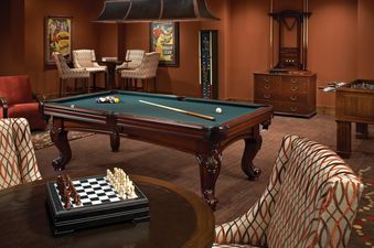 A spacious game room in Emerald Mountain One Steamboat Place 702 with a pool table, chess set, and foosball table.