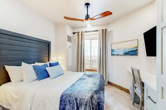 Westgate 4607AB features a comfortable bedroom with a king-size bed, a dresser, and a window with a view of the mountains.