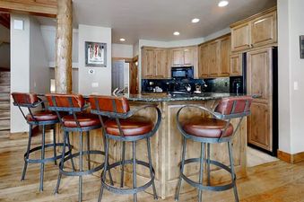 EagleRidge Townhomes 1516 kitchen features a unique design with bar stools hanging from the ceiling.