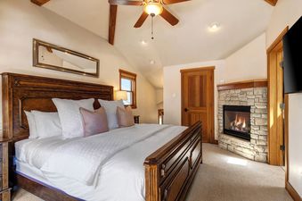 The bedroom in Abode at Dawn Patrol features a beautiful fireplace and large bed.